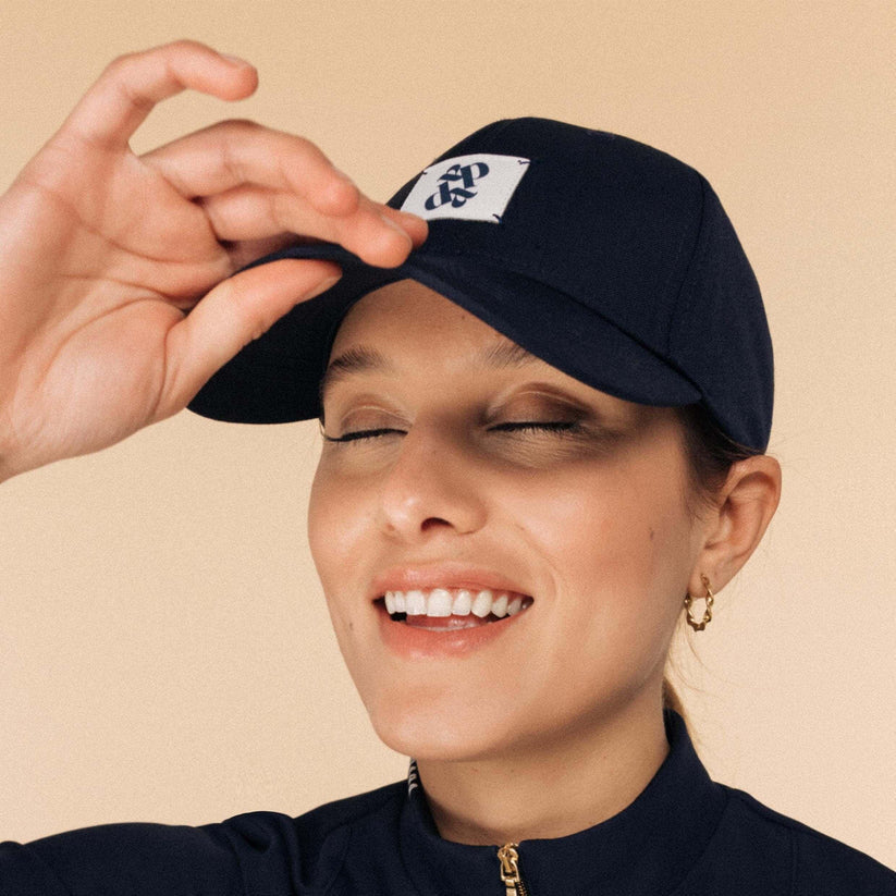 Dada Sport Arko Cap - STRĒID. Unisex rider baseball cap in Navy or Off White with UPF 50+ protection, Dada woven label, and adjustable gold clasp