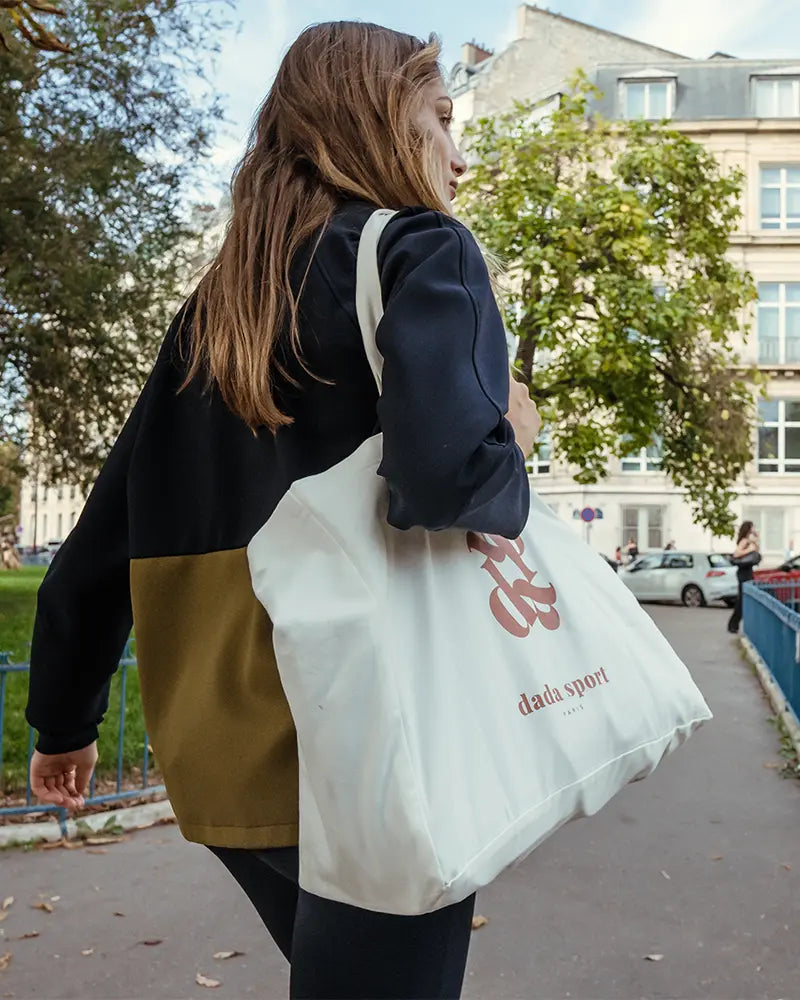 Dada Sport Marcelin Tote Bag Egg Shell - STRĒID. Soft, light cotton tote with double Dada monogram print, 28L capacity for everyday equestrian and casual use.