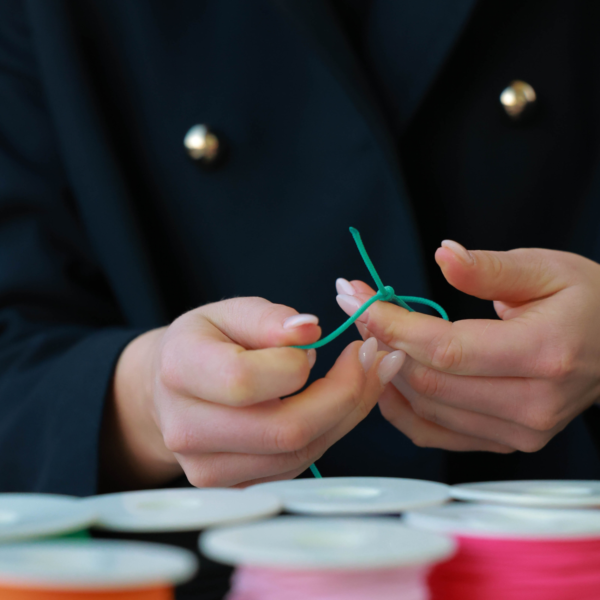 Silver Challenge Cord Bracelet in Aqua Blue by TOTI - Strēid. Vibrant monogram bracelet with aqua blue cord and empowerment symbolism.