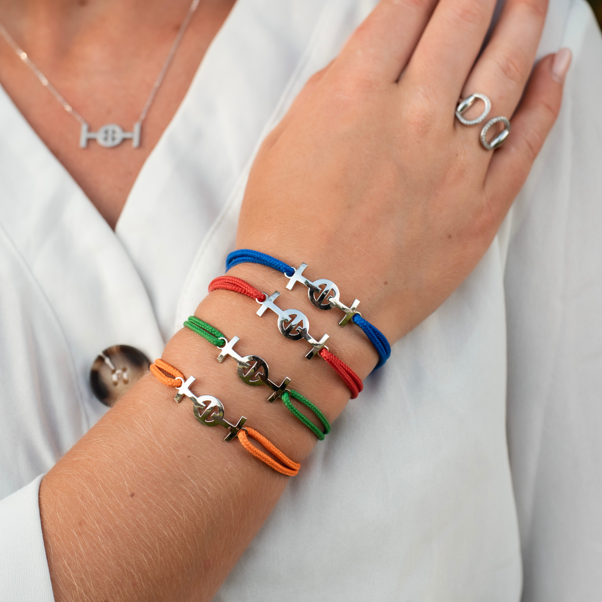 Silver Challenge Cord Bracelet in Green by TOTI - Strēid. Vibrant monogram bracelet with green cord and empowerment symbolism.