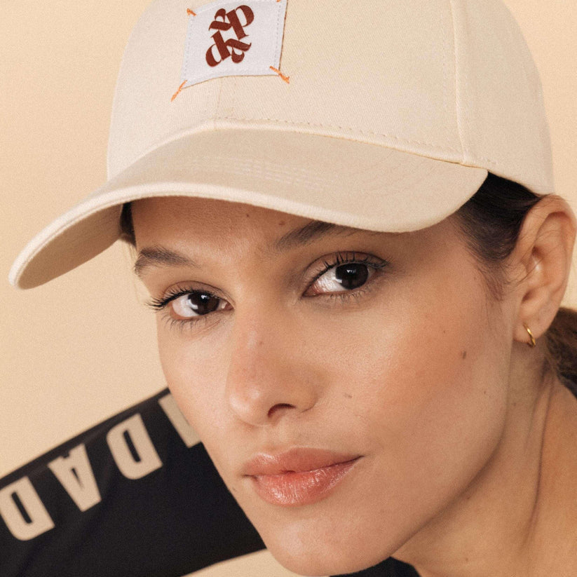 Dada Sport Arko Cap - STRĒID. Unisex rider baseball cap in Navy or Off White with UPF 50+ protection, Dada woven label, and adjustable gold clasp