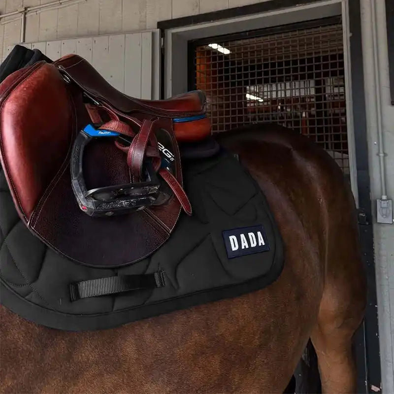 Dada Sport Fit for Fun Saddle Pad Navy - STRĒID. Ergonomic horse saddle pad in navy with neoprene padding, water-repellent layer, and unique Dada motif for comfort and performance.
